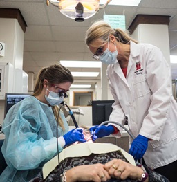 Dental Hygiene Student and Faculty Member Working in Clinic.