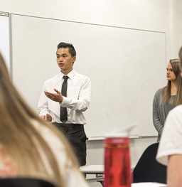 Faculty and students in a class discussing a communication topic