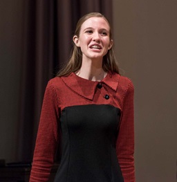 Student on stage speaking passionately.