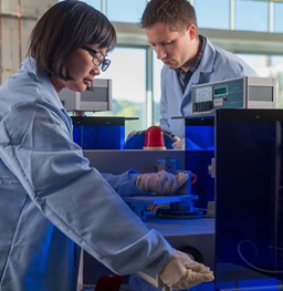 Two students doing research in a lab.