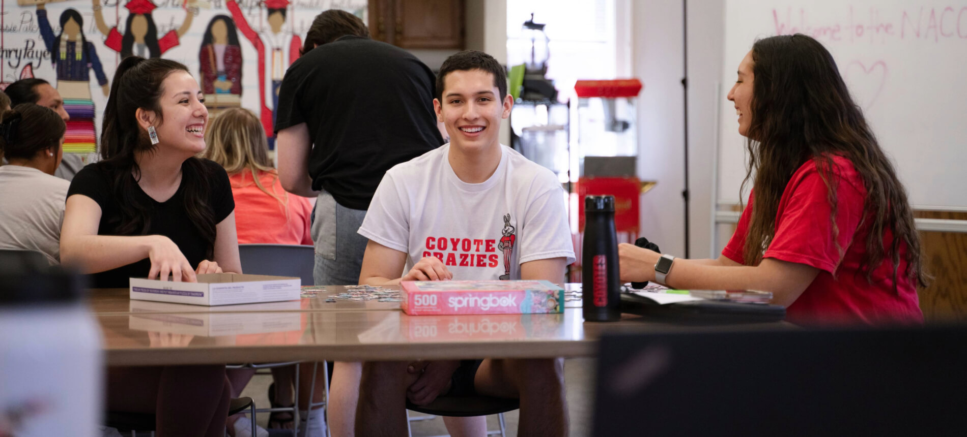 Three students sitting in the NSS lobby.