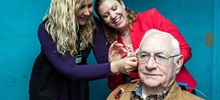 Two audiologists with male patient.