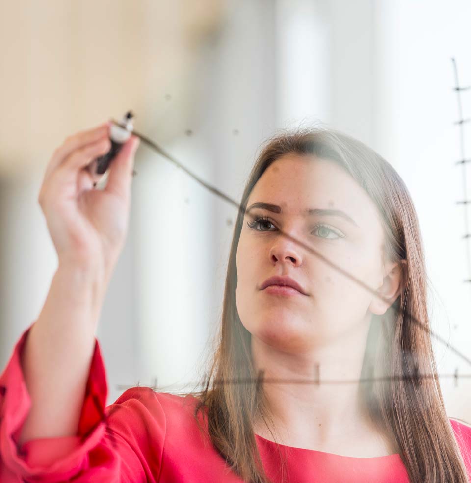 A student writing on a board.