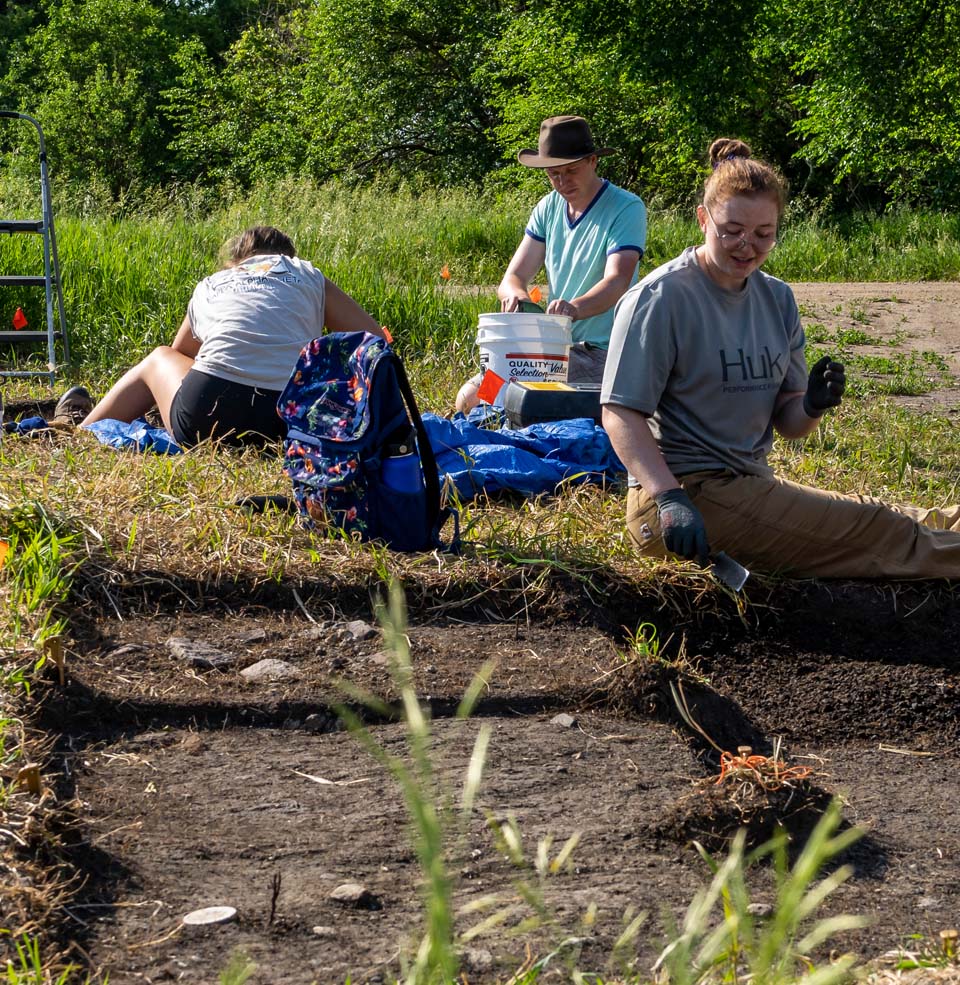 Students working in the dirt doing archeology research