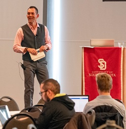 Faculty presenting at a podium