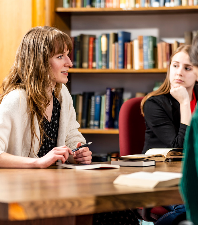English students meeting at a desk.