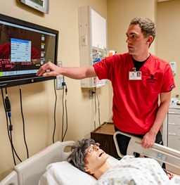 Nursing Student Taking Care of a Patient in a Simulation