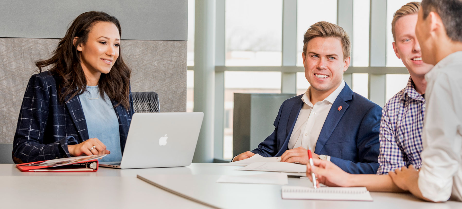 4 students talking in class at Beacom.