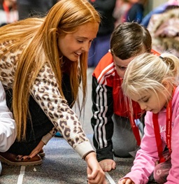 a female student working with two young children