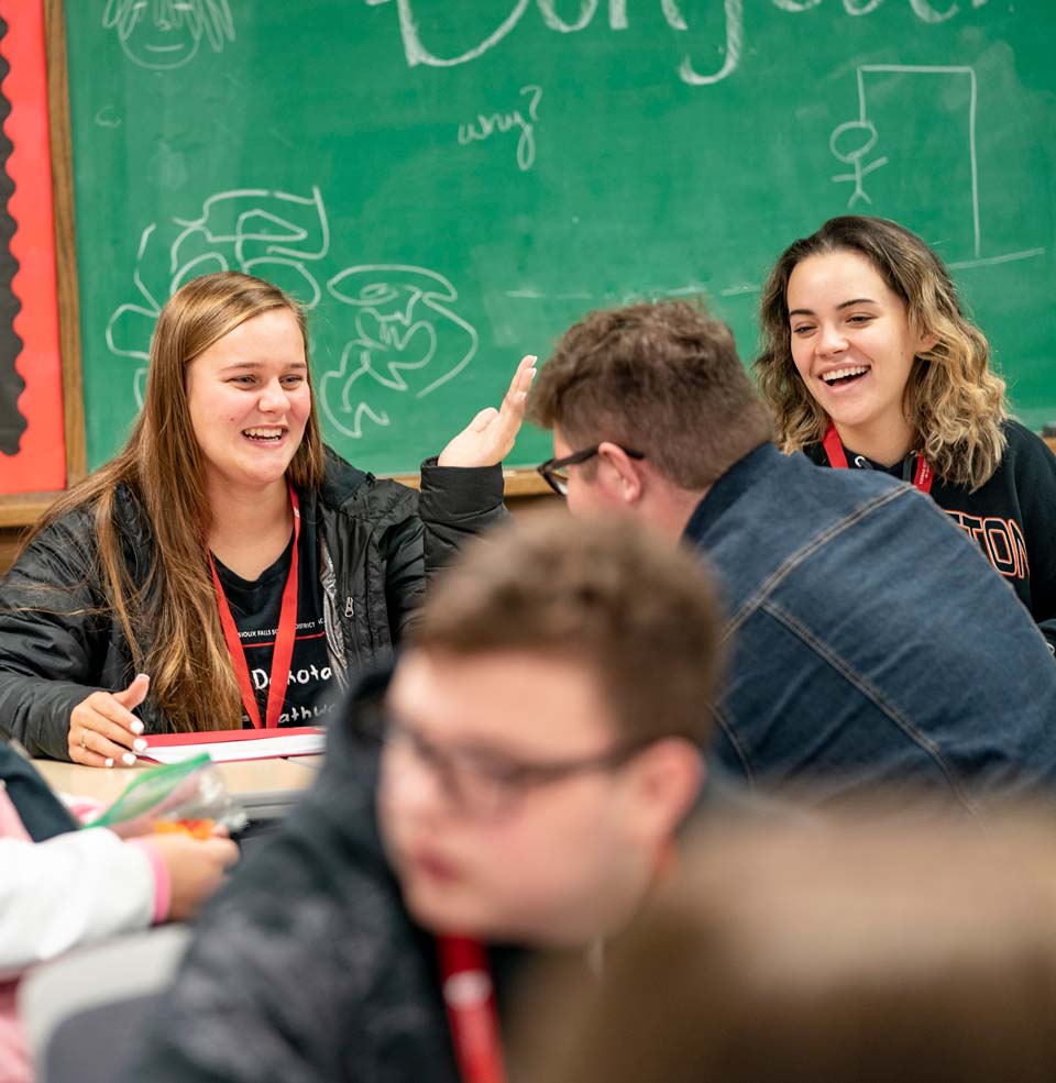 Students in a classroom laughing.