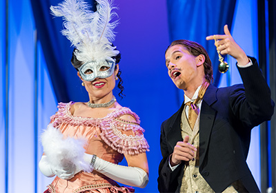 Two opera performers singing on stage.