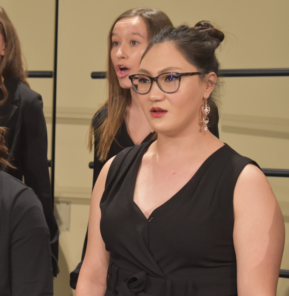 The USD collegium musicum singing on stage.