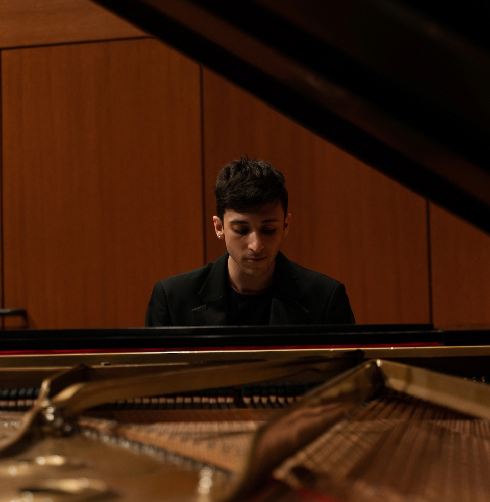 A student performing on a grand piano in Colton Hall.