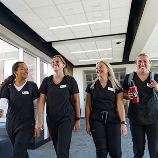Health sciences students walking down the hallway.