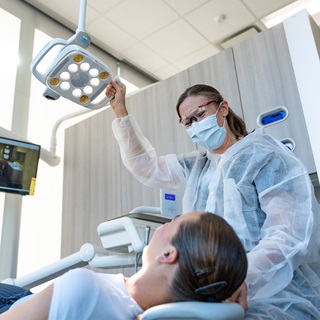 A dental hygienist working on a patient.