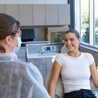 A dental hygienist working on a patient.