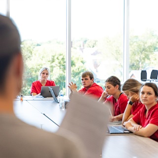 Health science students in a classroom at the table.