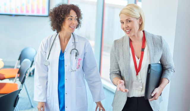 two women walking in a hallway