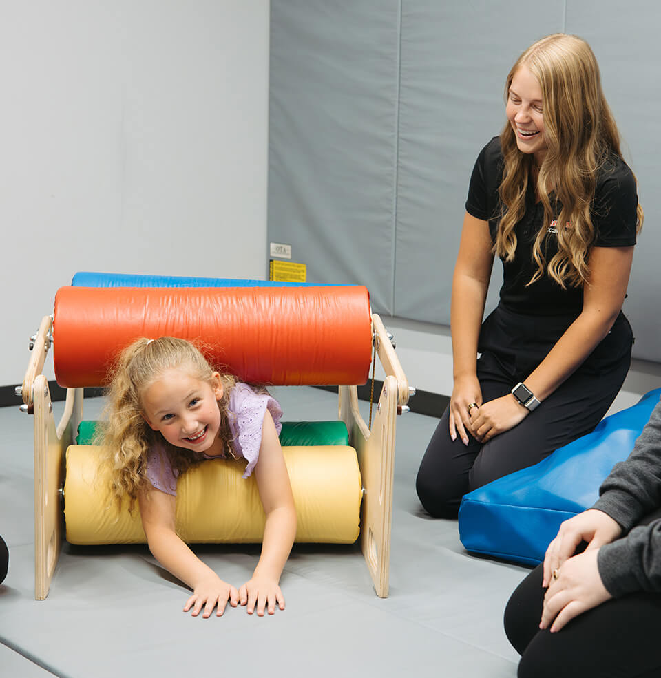 child playing with OT student