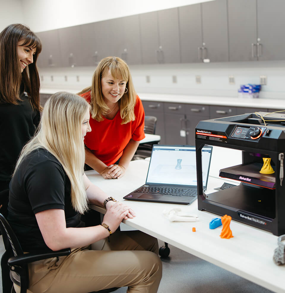 students working at a 3d printer