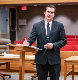 Law Student Standing at a Lectern.
