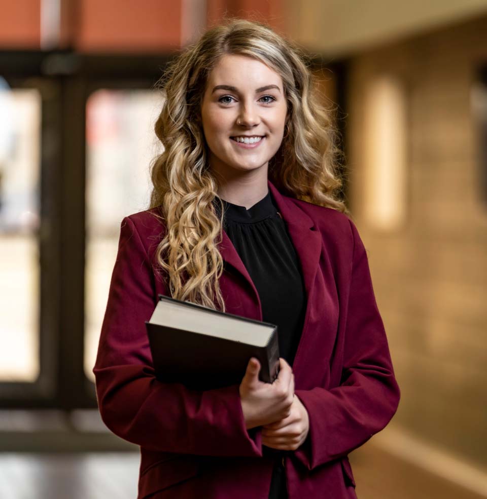 Female Law Student Smiling and Holding Book