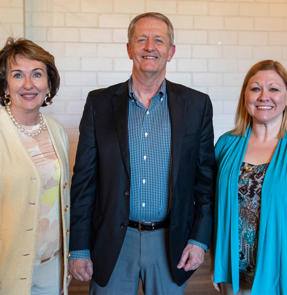 Dean Ridgway and company smiling into the camera.