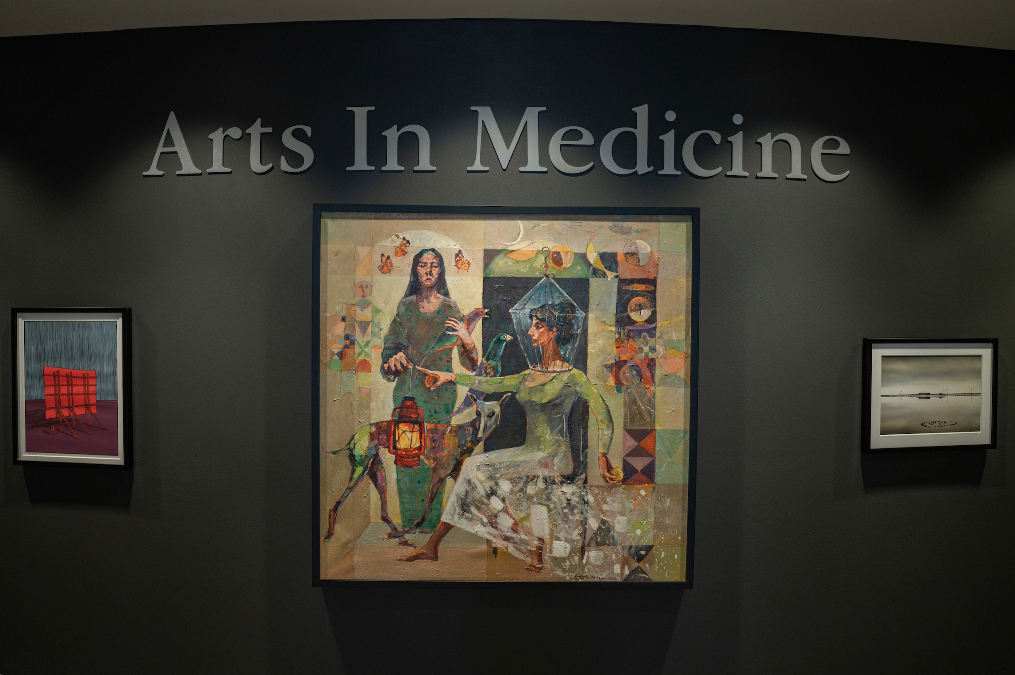 Student paintings hanging on the wall in the Parry Center's Arts in Medicine Gallery.