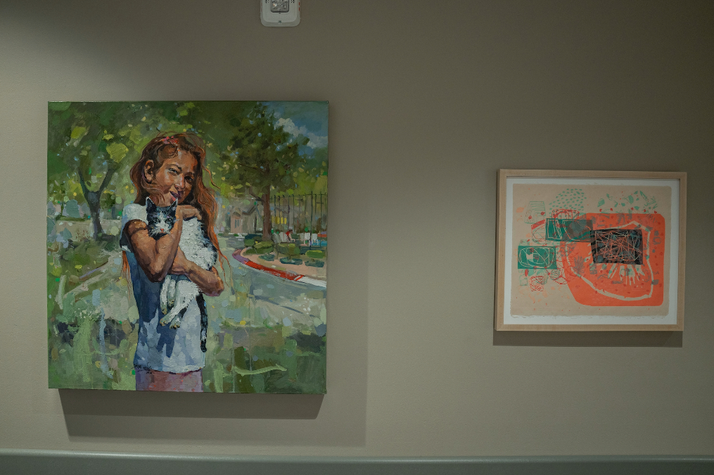 Student paintings hanging on the wall in the Parry Center's Arts in Medicine Gallery.