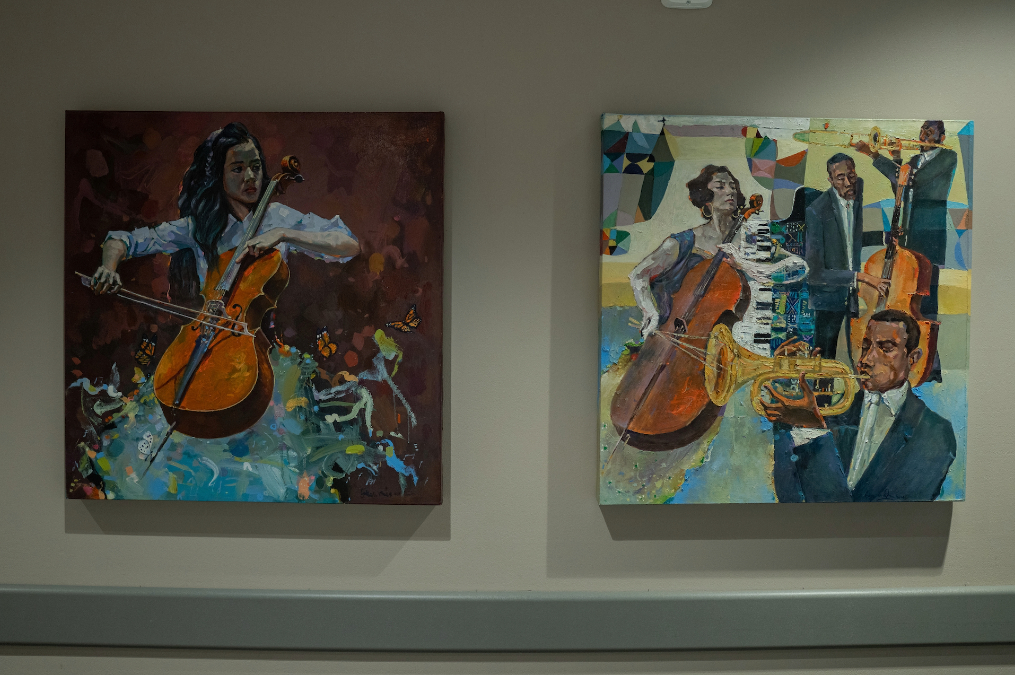 Student paintings hanging on the wall in the Parry Center's Arts in Medicine Gallery.
