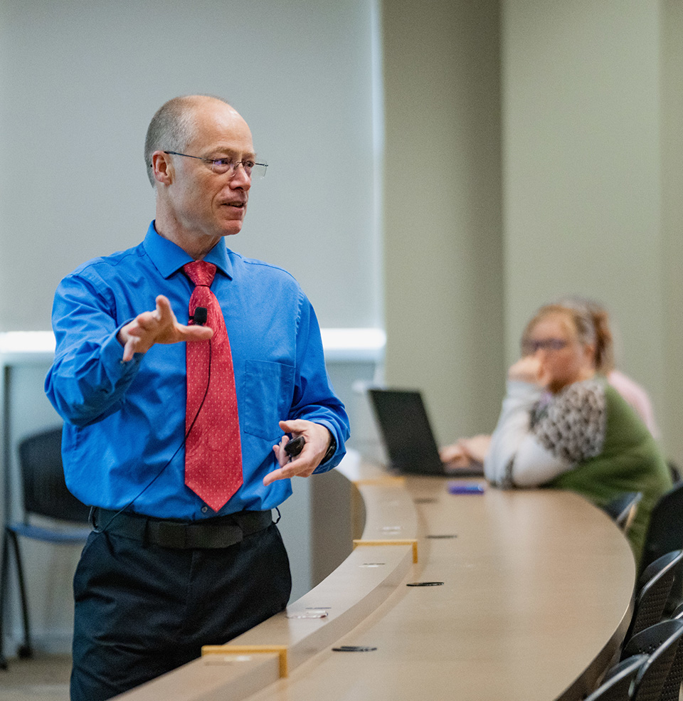 A faculty member for the med school instructing students.