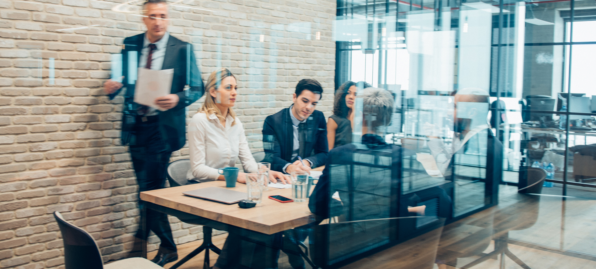 Business people in a meeting at a desk.