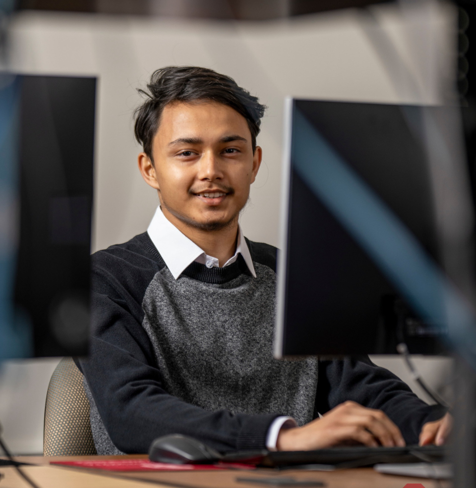 A computer science student at their computer.
