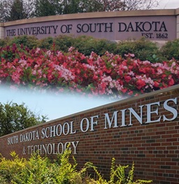 A USD brick sign combined with the South Dakota school of mines and technology brick sign.