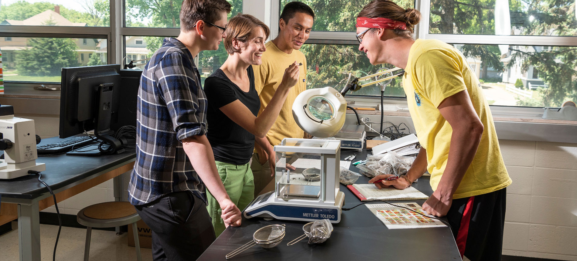 Students looking at something very small