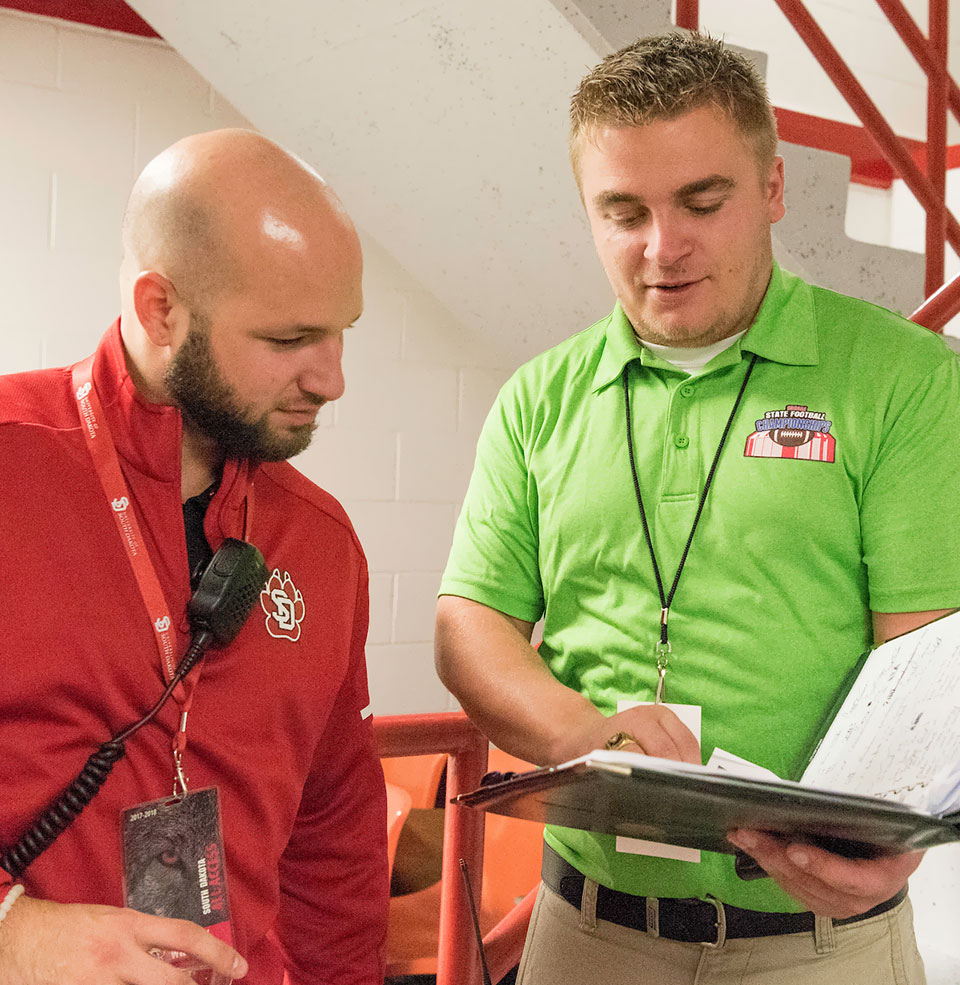 Two KSM students reading a book together.
