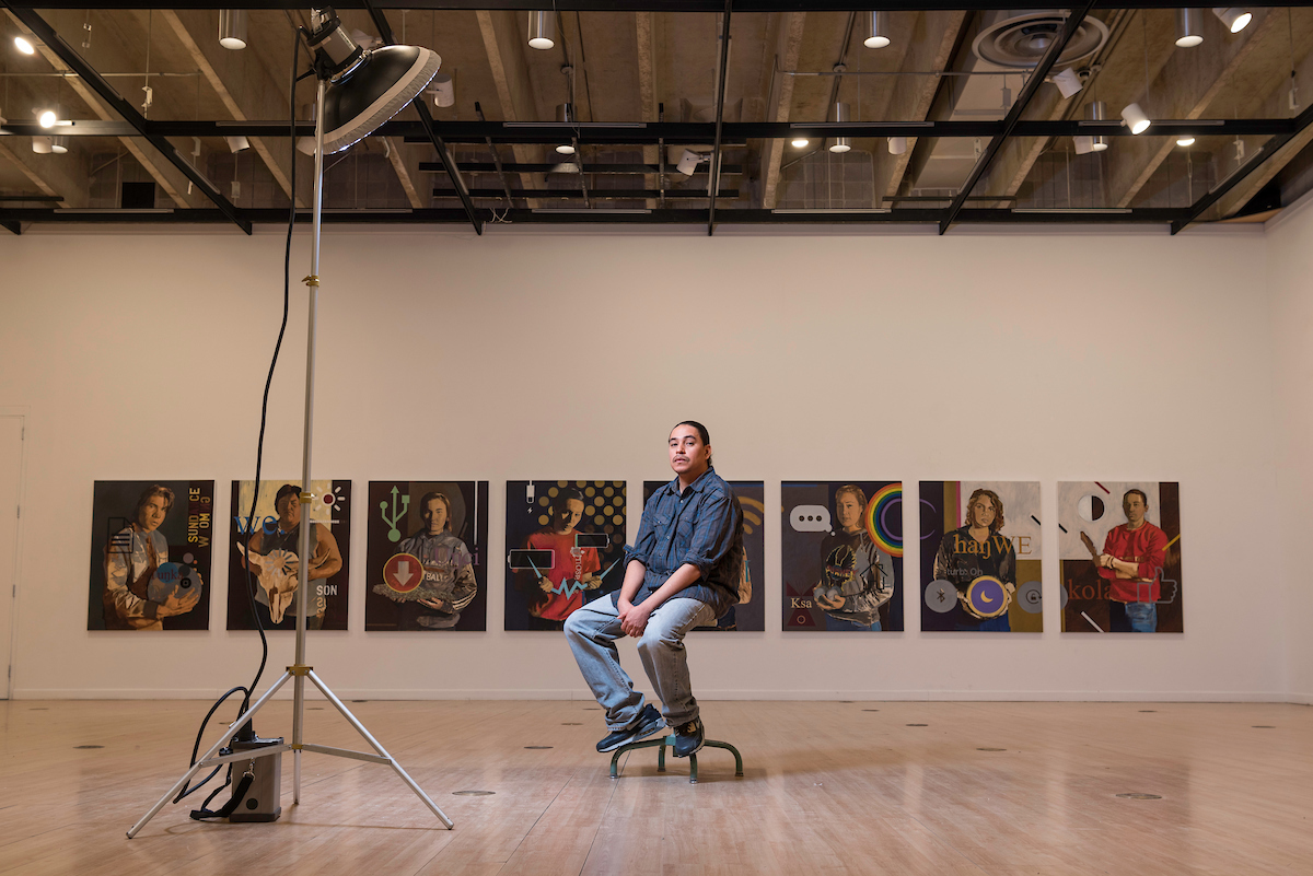Student in a gallery during a photo shoot