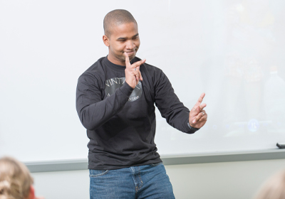 A man signing in American Sign Language.