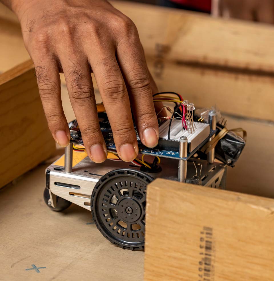 Hands working on a robot