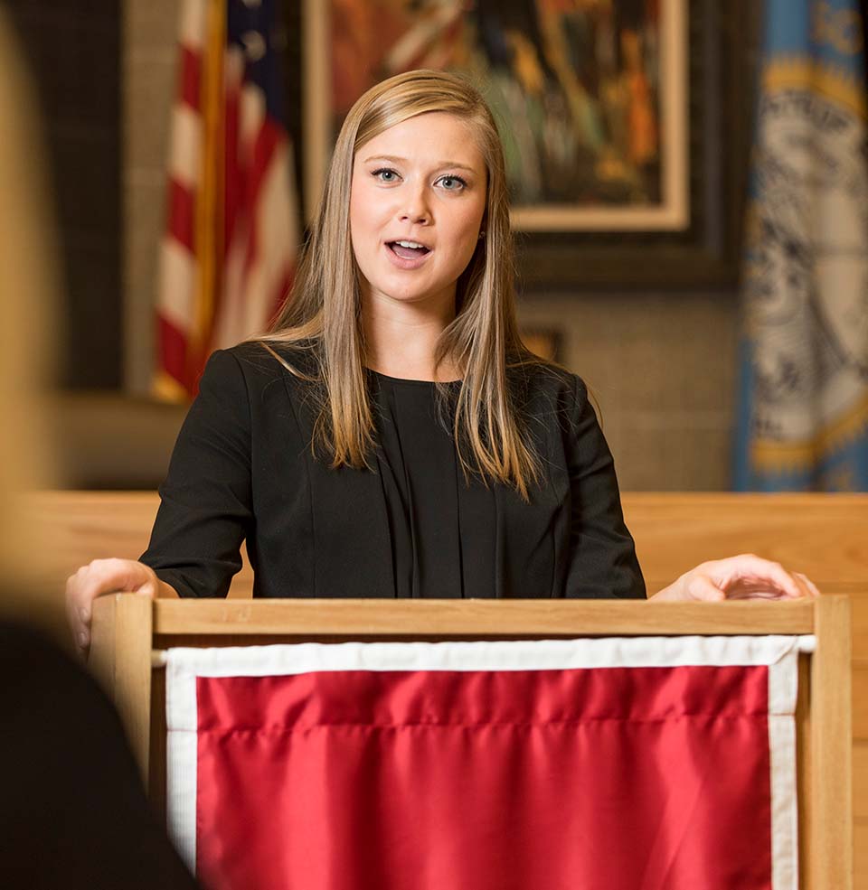 Student standing at podium.