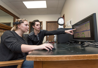 Two Students Utilizing a Research Lab.