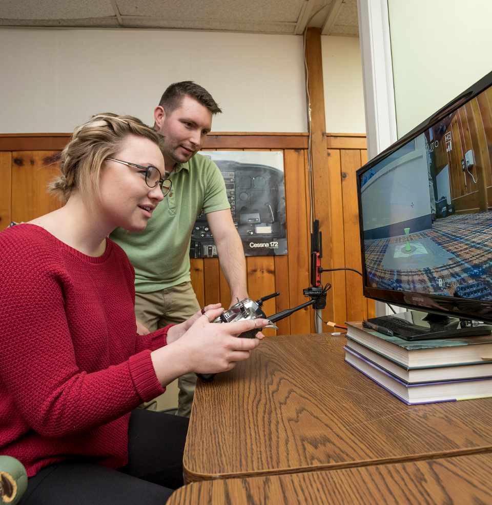 Two Students Utilizing on of the Psychology Research Labs.