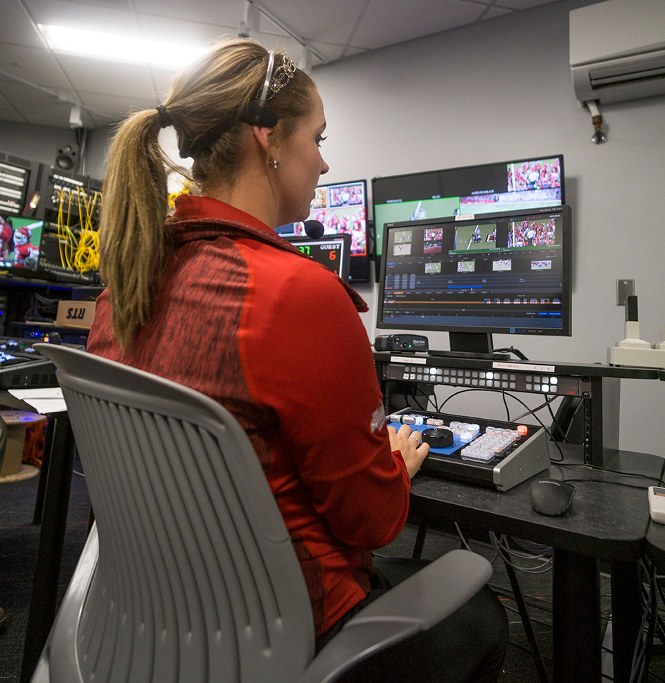Female Student Working Control Board During Sporting Event