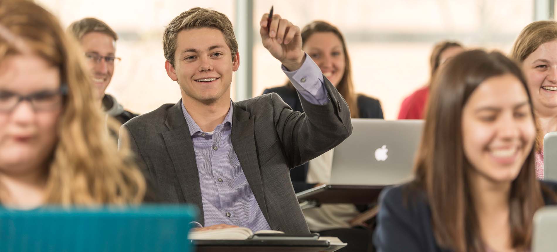 Male Student Interacting with Professor During a Lecture.