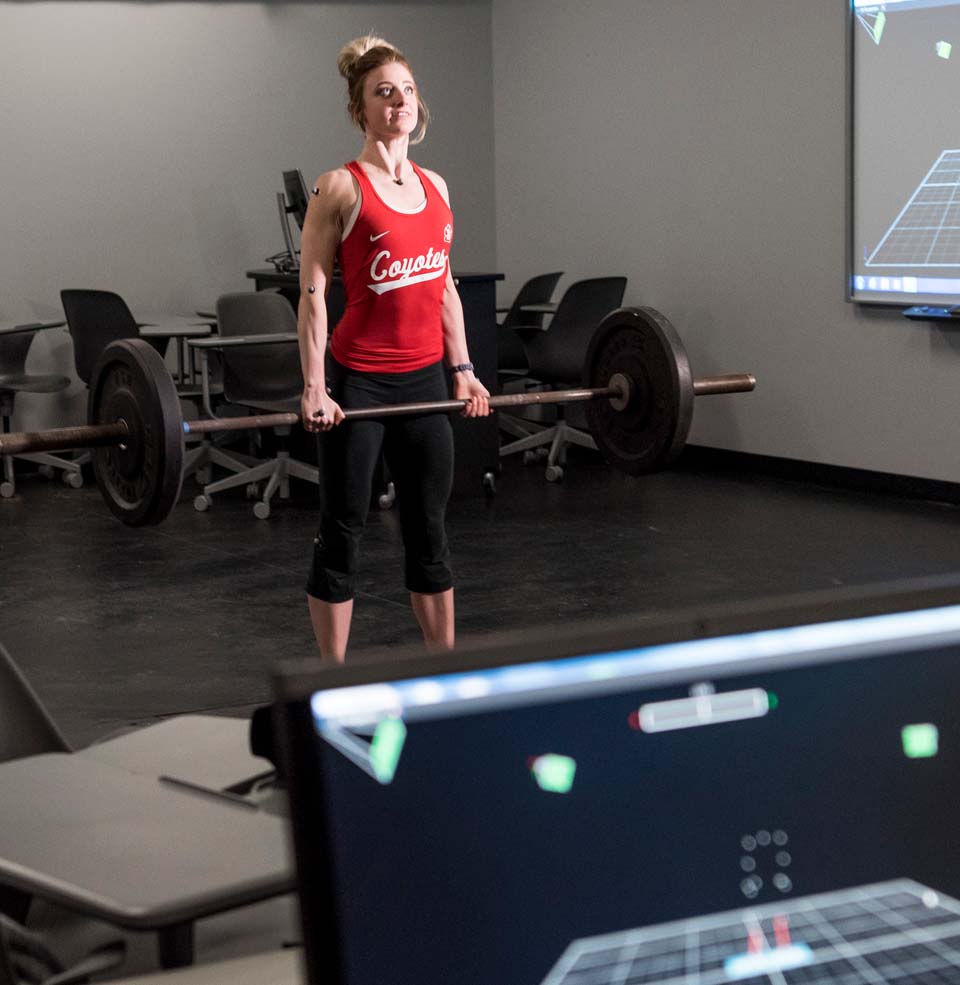 A student being analyzed lifting something.