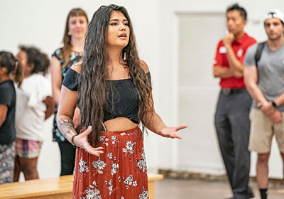 A student speaking at the Oscar Howe art gallery.