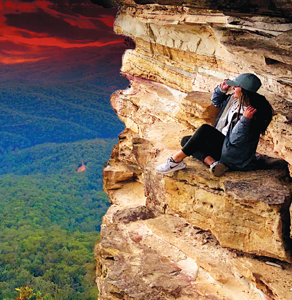 A student rock climbing in a foreign country.