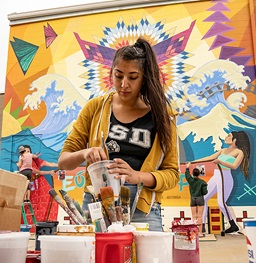 USD students involved in community art mural projects.