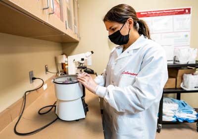 Student Using Lab Equipment for Medical Research