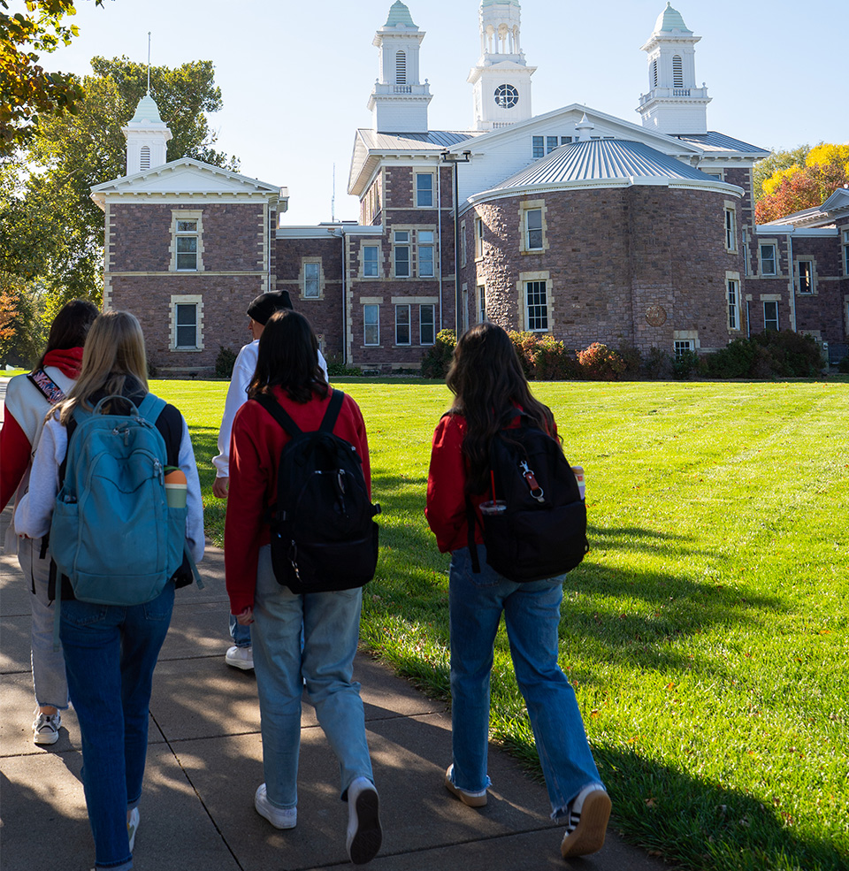 Students walking on campus in front of Old Main